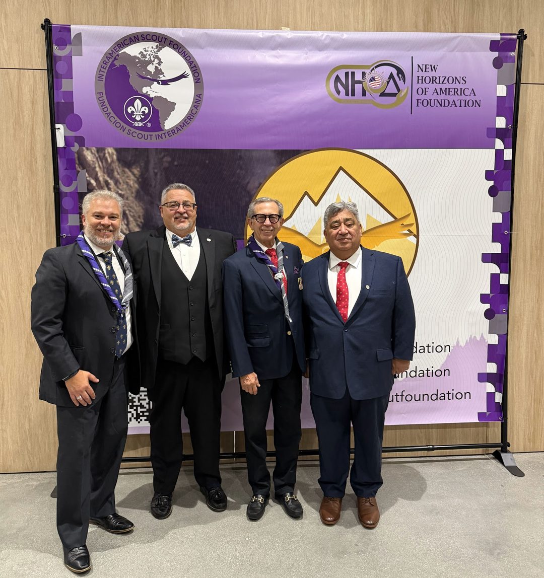 IASF and New Horizons of America Foundation leaders in front of the two organizations' joint event banner