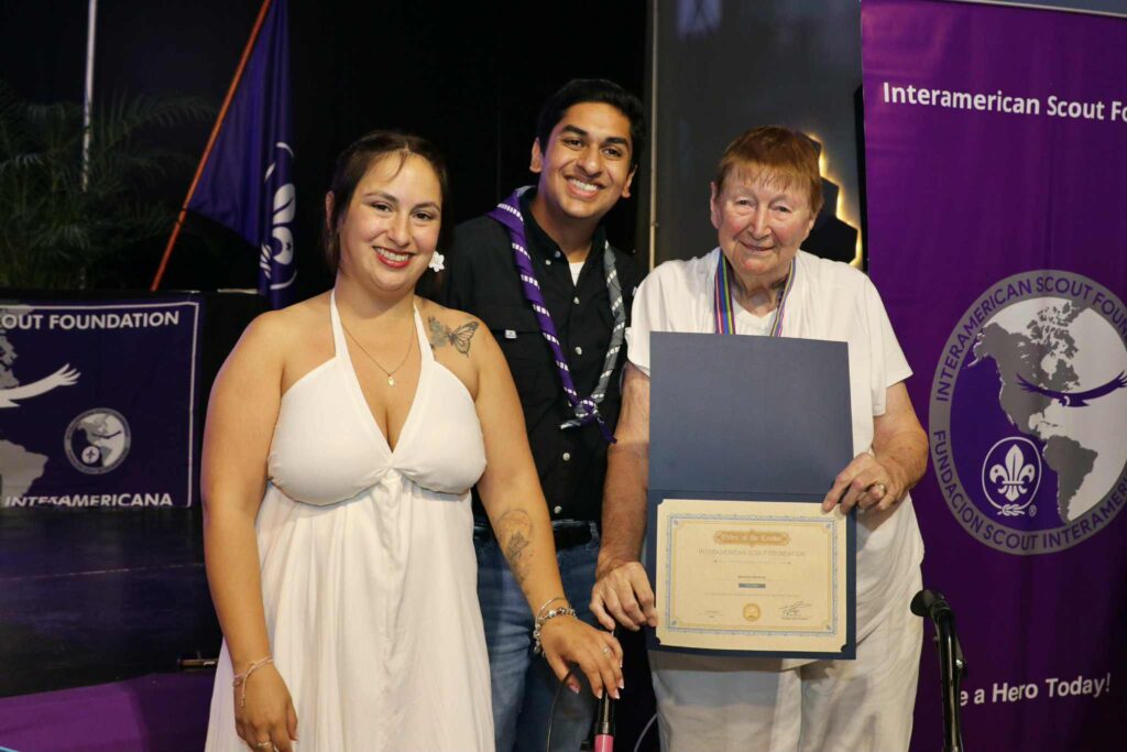 A recognition certificate is presented at an Interamerican Scout Foundation celebration